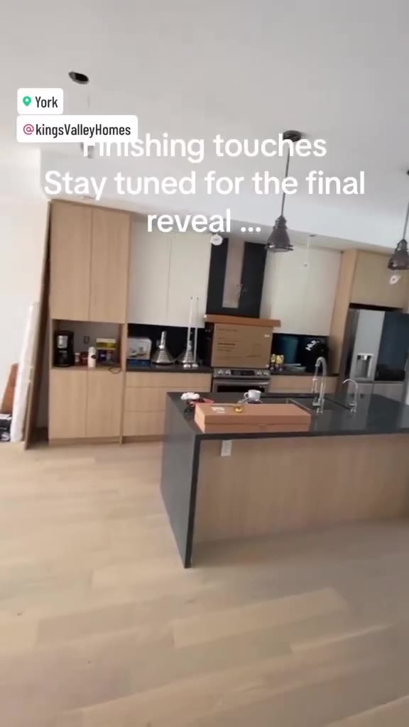 Finished kitchen with light wood cabinetry and island
