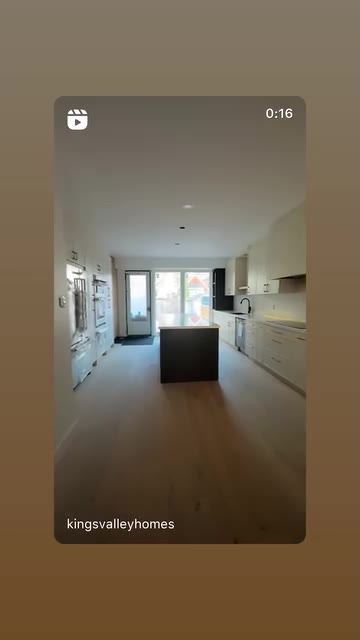 Finished white kitchen viewed from the hallway