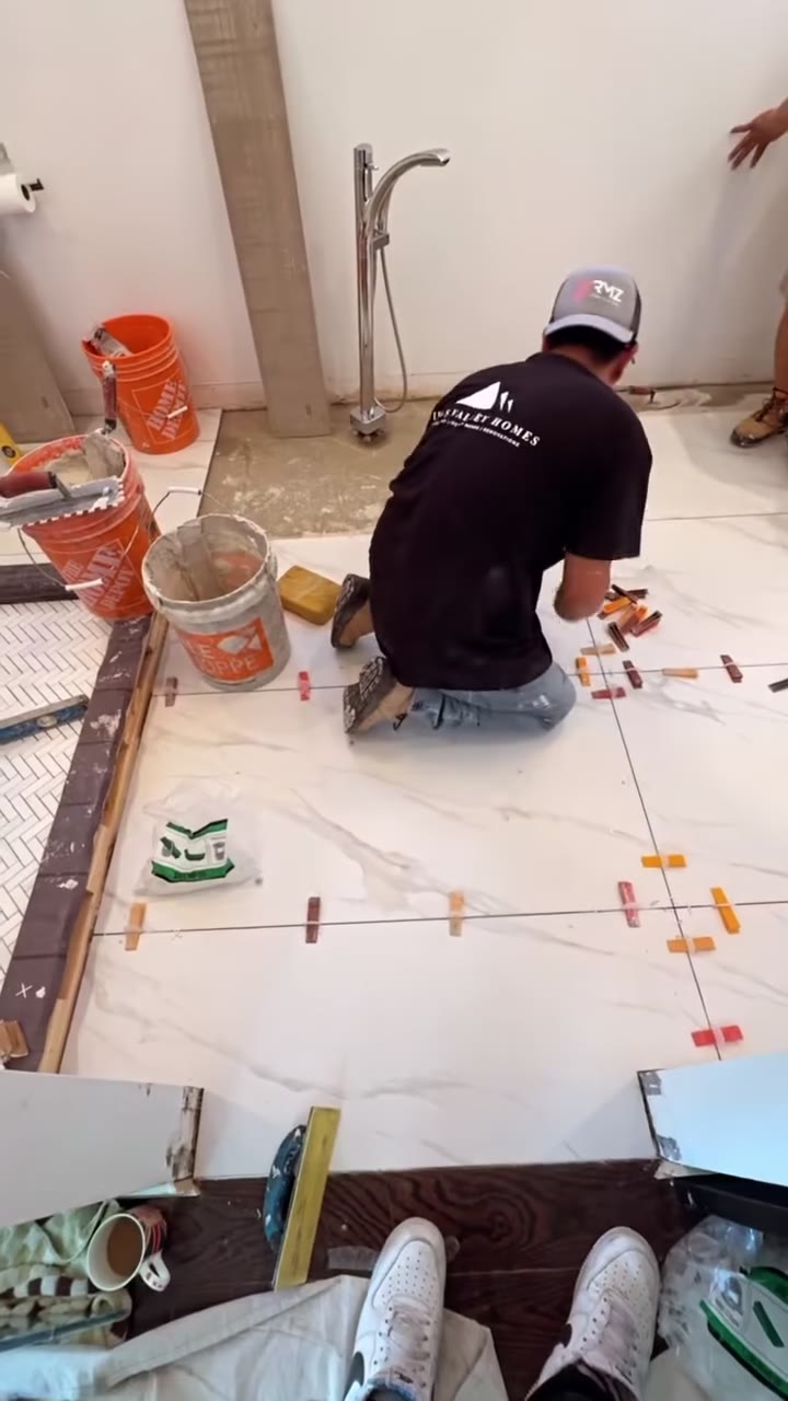 Installer laying large-format floor tile