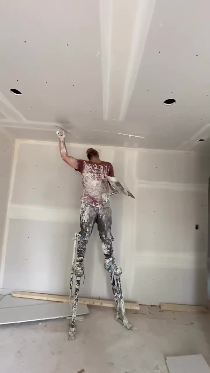 Drywall installer finishing an interior wall
